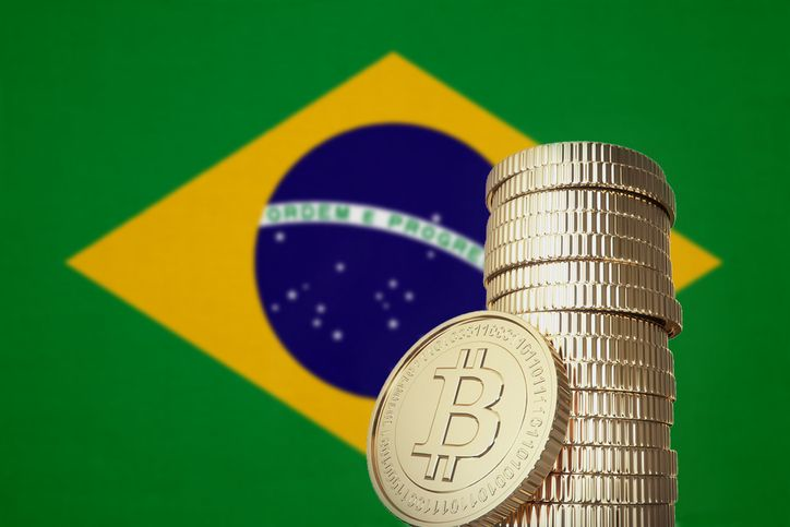 Bitcoin stack with Brazil flag in the background - stock photo
