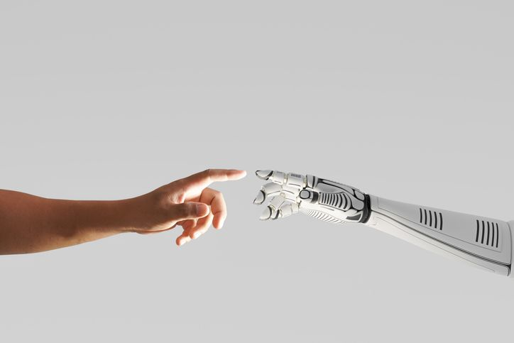 Robot hand touching with human hand - stock photo