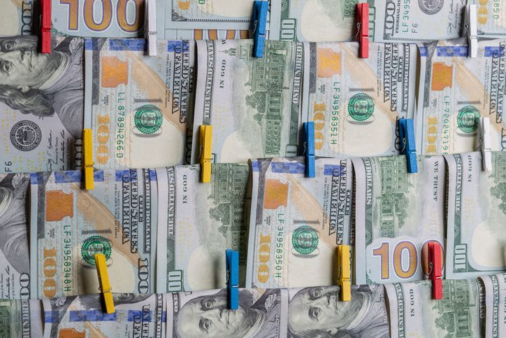 Anti-Money Laundering concept. AML. US Dollars hanging on ropes - stock photo