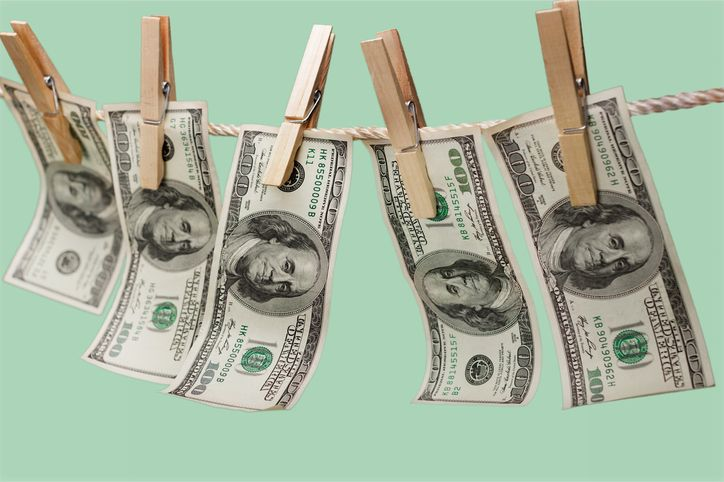 A stock photo featuring five two-dollars bills fixed with the clothes peg. 