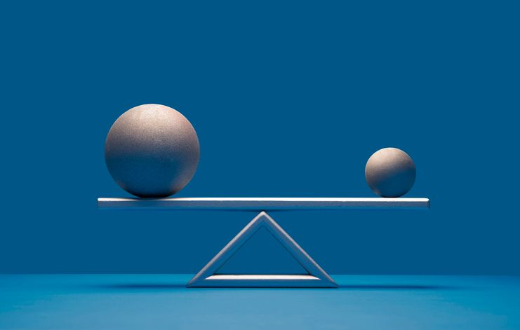A stock photo featuring two balls balancing on the scale. 