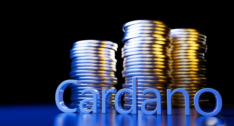 A stock photo featuring a 3D "Cardano" inscription and a stack of coins