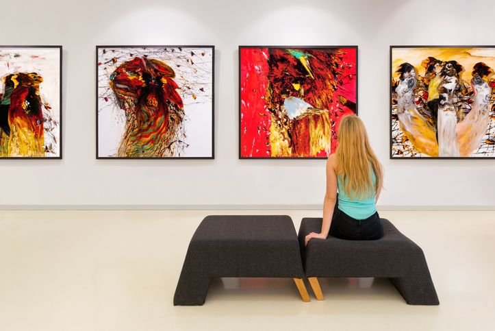 A stock image of girl looking at the art in the gallery.