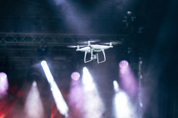 A stock image of the flying drone in stage lights.