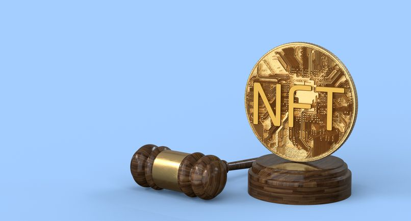 A stock photo featuring an NFT coin and a gavel. 