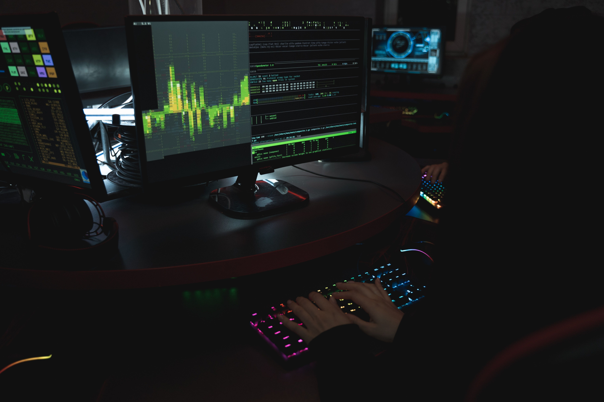 Person using a desktop computer in a dark room