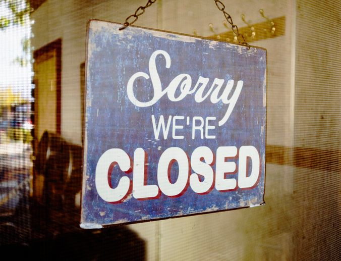 Closed sign on glass door - stock photo