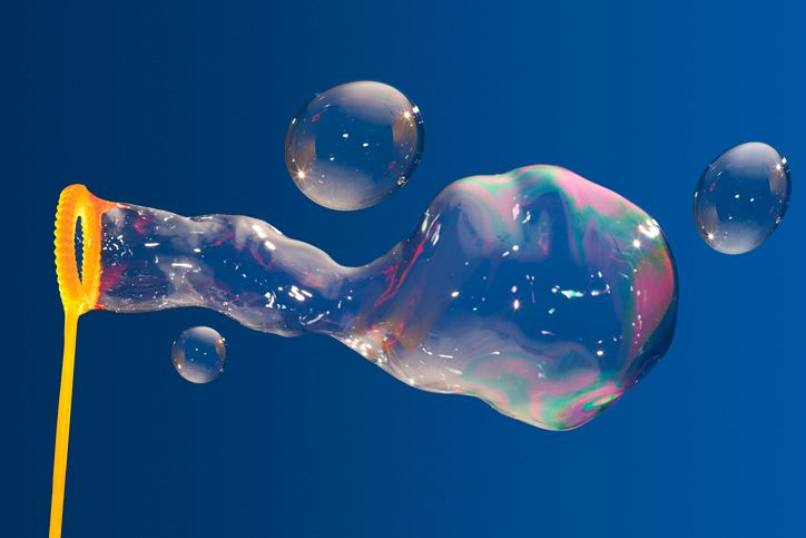 A stock photo of a bubble wand and soap bubbles. 