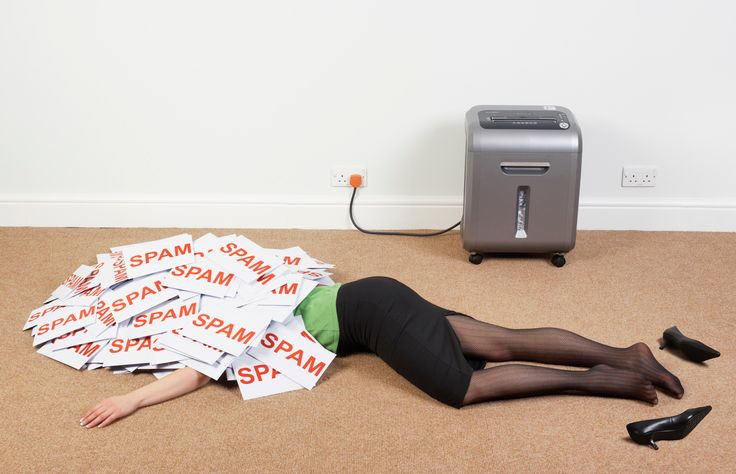 A stock photo of a businesswoman lying on floor with a pile of spam mail. 
