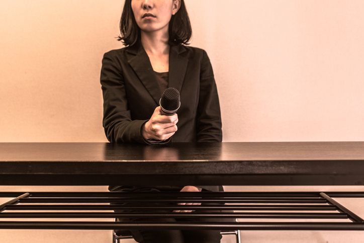 A spokeswoman for the company holding a microphone - stock photo. 