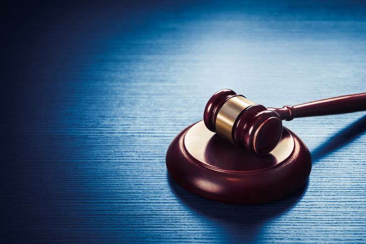 Judge gavel on a blue wooden background - stock photo