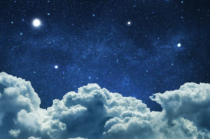 Starry night sky with clouds - stock photo