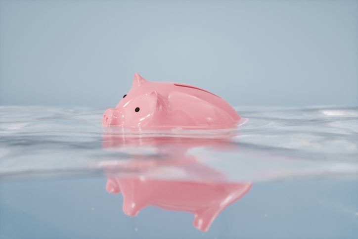 A stock photo of a sinking piggybank. 