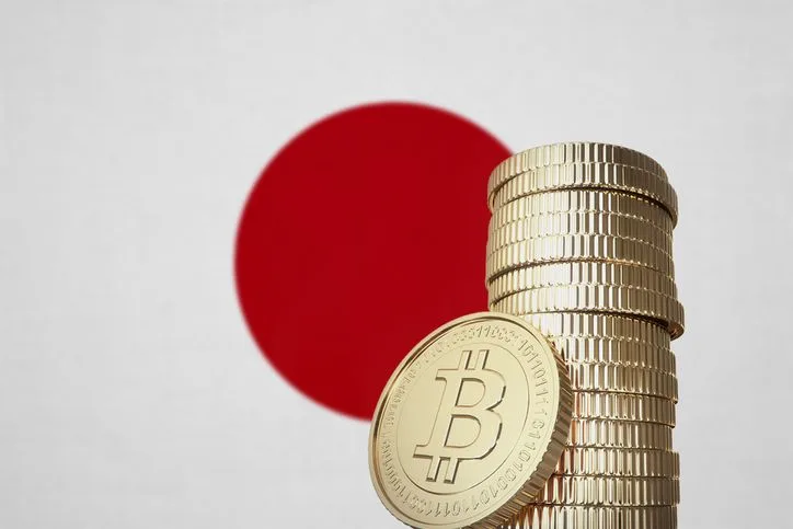 Bitcoin stack with Japan flag in the background - stock photo