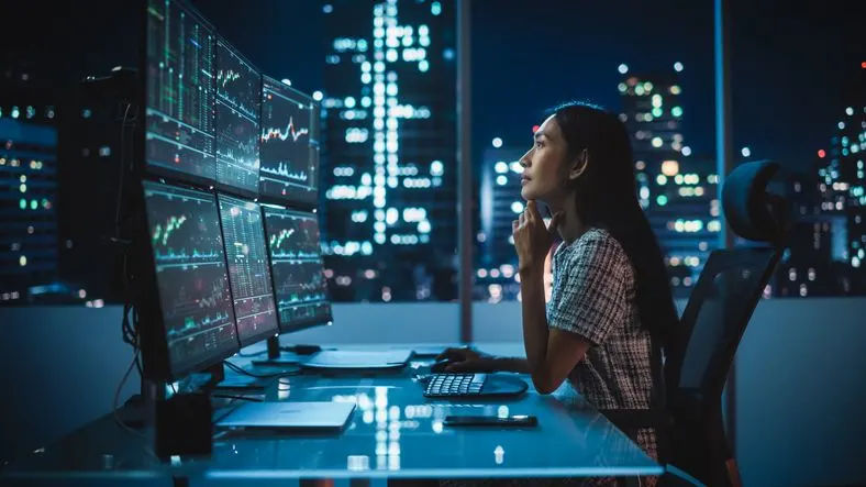 Woman looking at the charts on the monitors