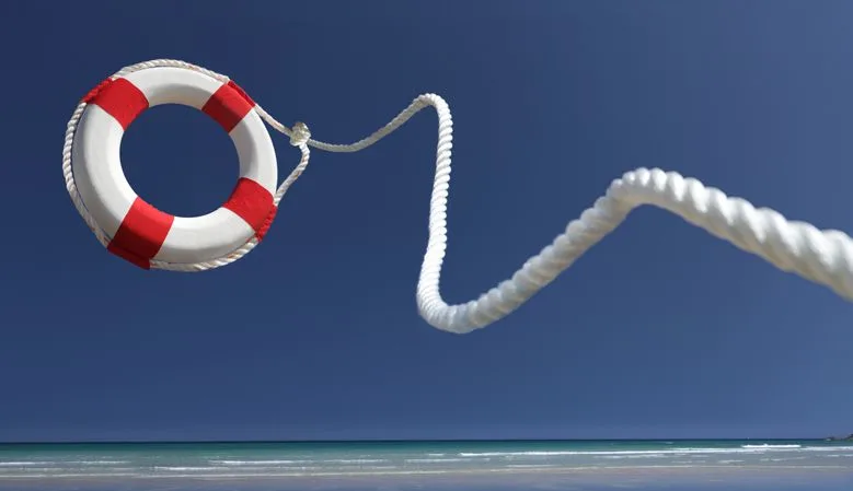 Lifering in air on beach - stock photo