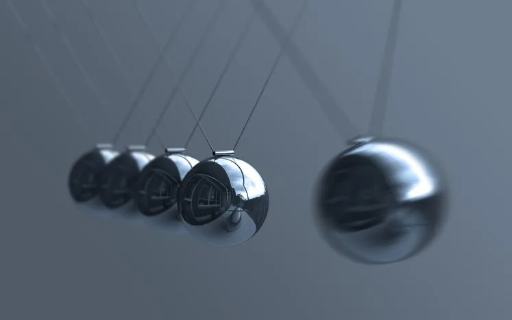 A stock photo featuring Newton's cradle. 