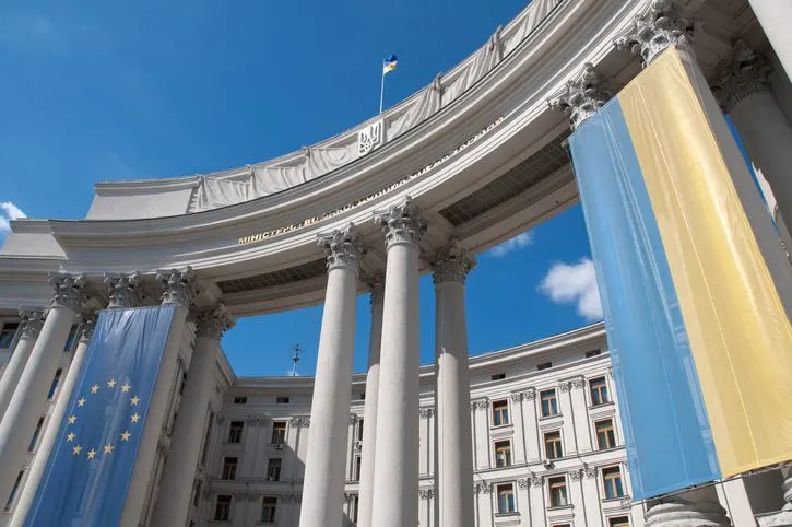 A stock photo featuring Ukrainian and EU flags hanging from the Ukrainian Ministry of Foreign Affairs government building in Kiev, Ukraine.