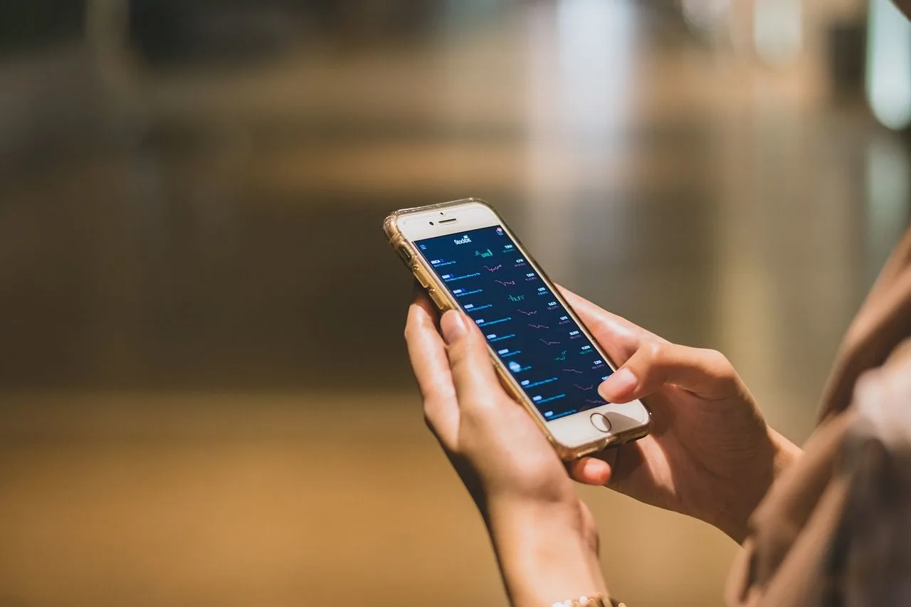 Woman using her phone for trading