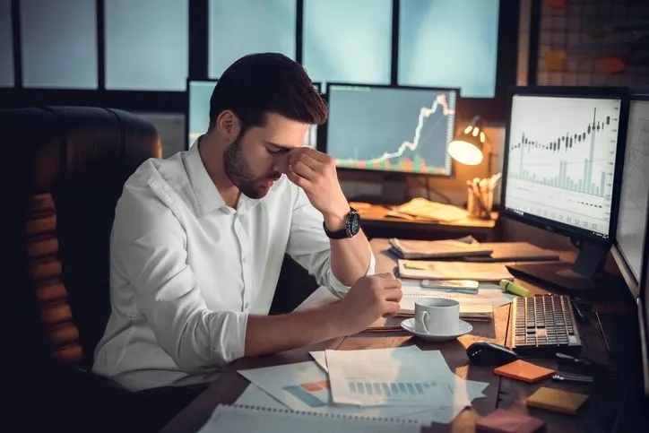 Depressed trader at his desk