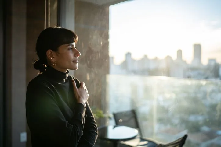 Young woman looking out a window