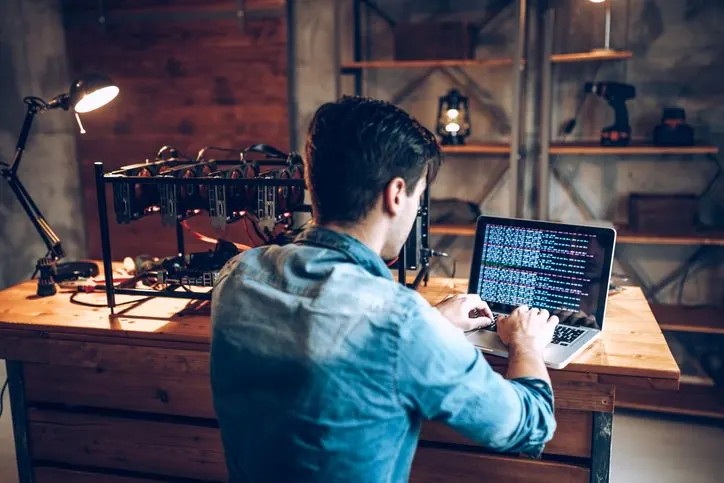 A stock photo of an IT guy setting his first mining rig. 