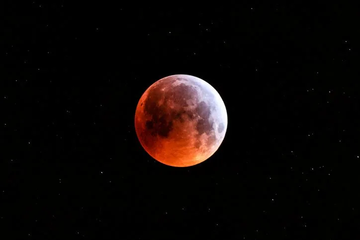Blood moon in a dark sky