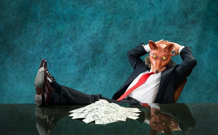 A stock photo featuring businessman with stack of banknotes wearing fox mask.