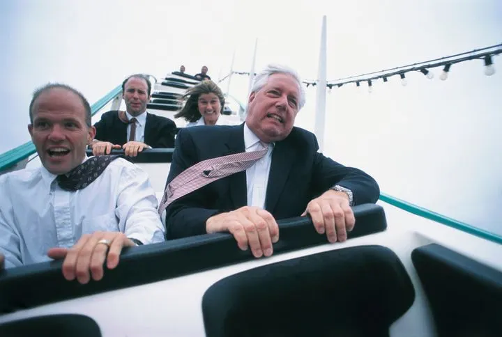 A stock photo of businessmen on rollercoaster.