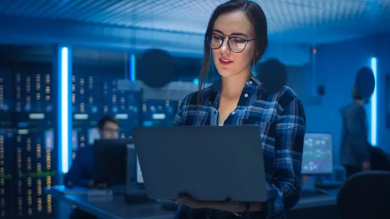 Cyber security specialist looking at her laptop