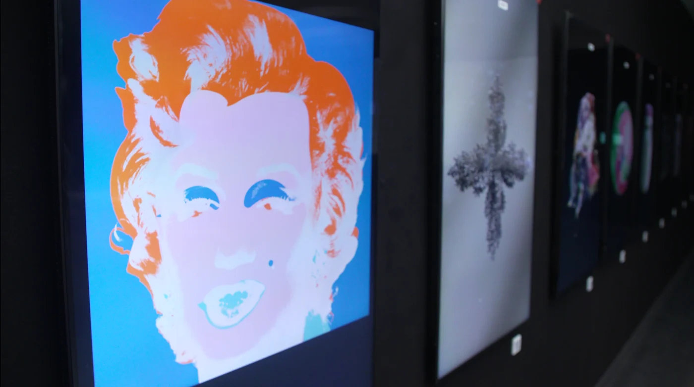 Andy Warhol's "Silver and Blue Marilyn" displayed on a screen at ArtMeta's Art Basel event.
