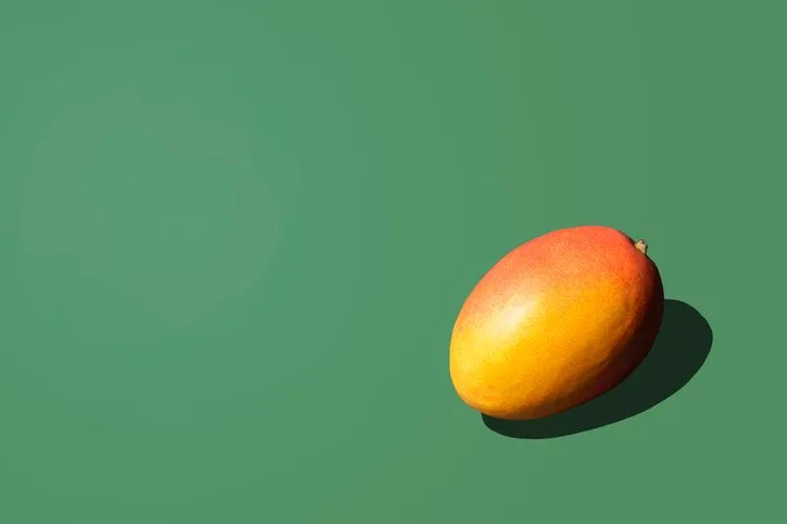 Fresh Mango on the green background