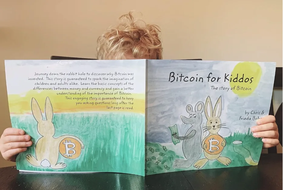 Bitcoin for Kiddos book cover held by a boy