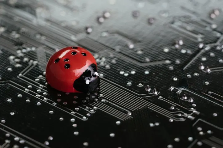 A stock photo featuring a ladybug on the circuit board.