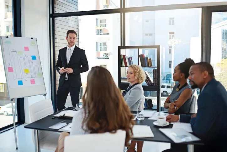 A stock photo featuring five people of different ethnicities during the work meeting.