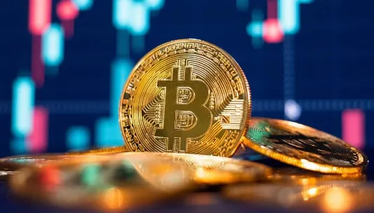 bitcoin in front of a trading screen