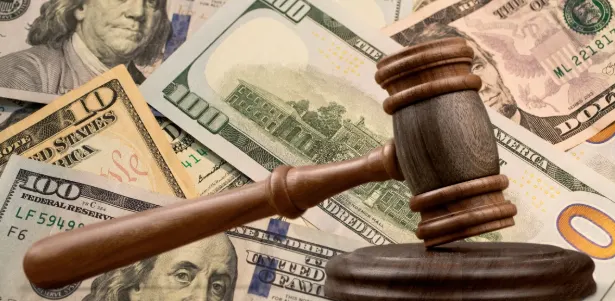 A gavel with money in the background