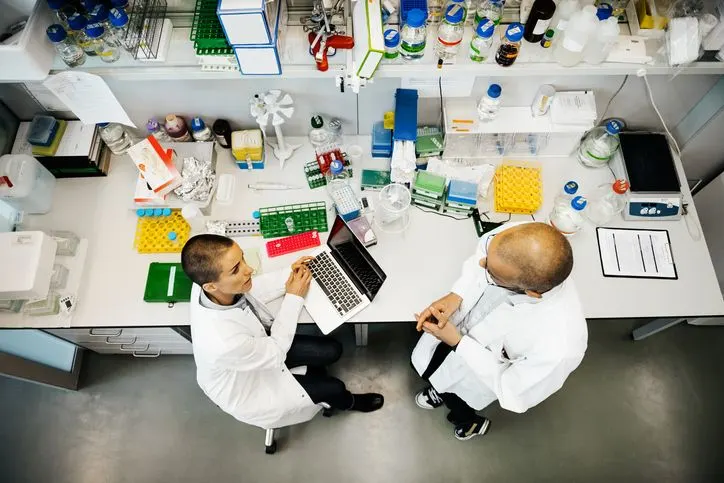 A stock photo of two scientists working together in a lab. 